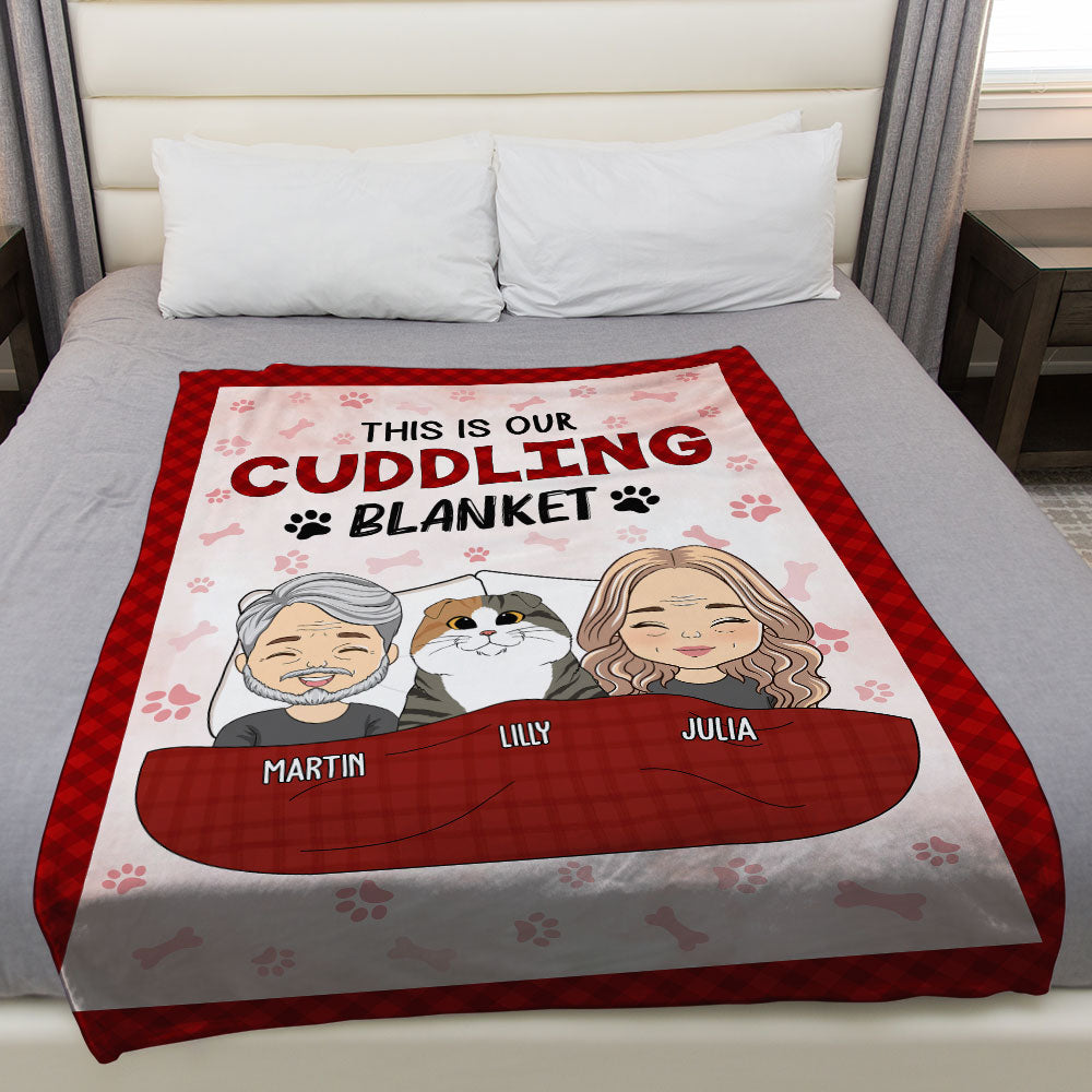 Red and gray fleece blanket with cartoon couple and dog illustrations, personalized names, and cuddling theme text.
