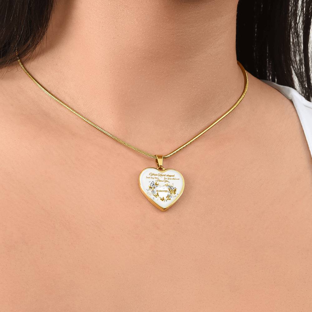 Gold heart-shaped pendant necklace with engraved sentimental message on delicate chain.