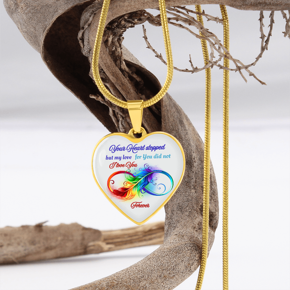 Gold heart-shaped pendant necklace with colorful heart design and blue script text on white background.