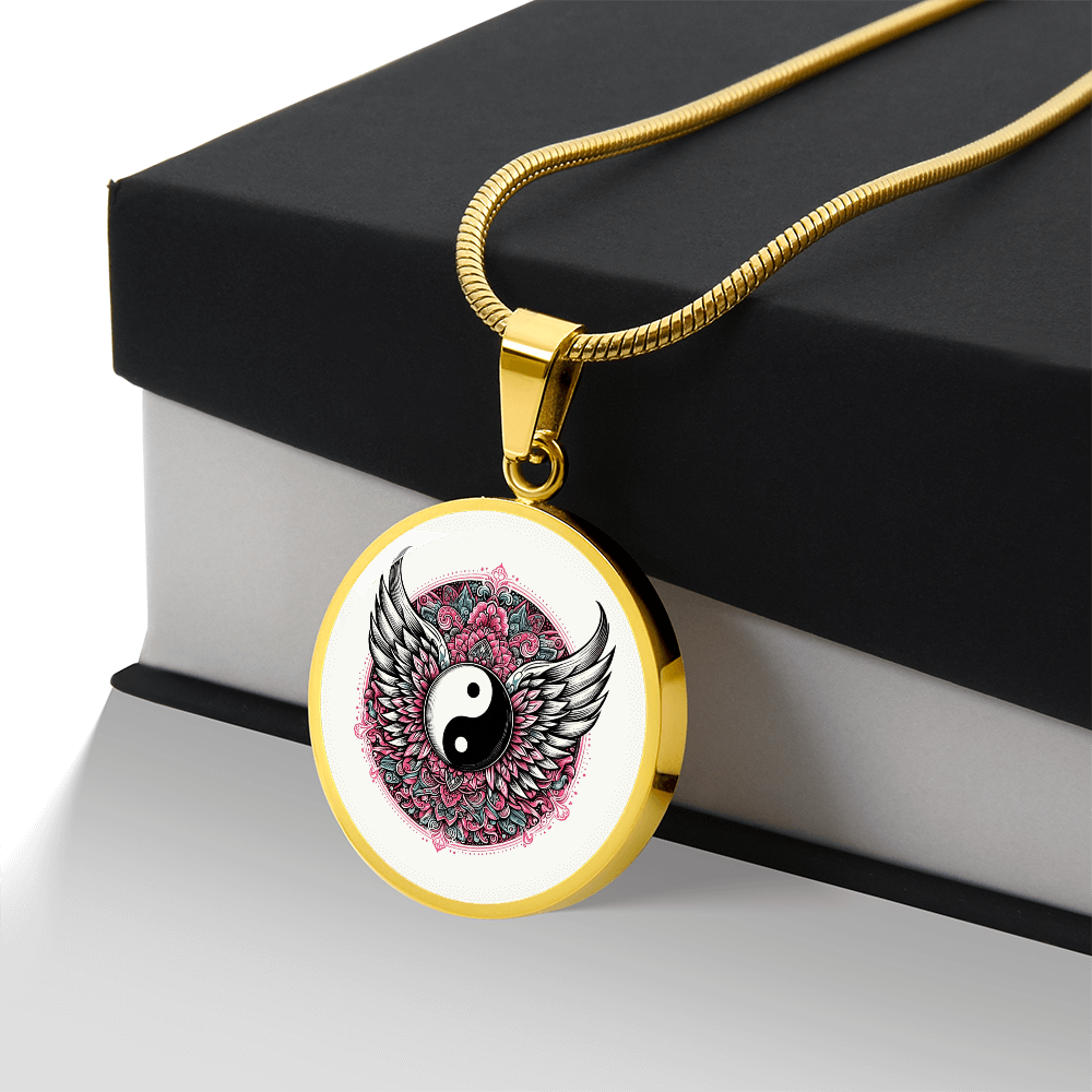 Gold necklace with circular pendant featuring yin yang symbol, angel wings, and pink floral design.