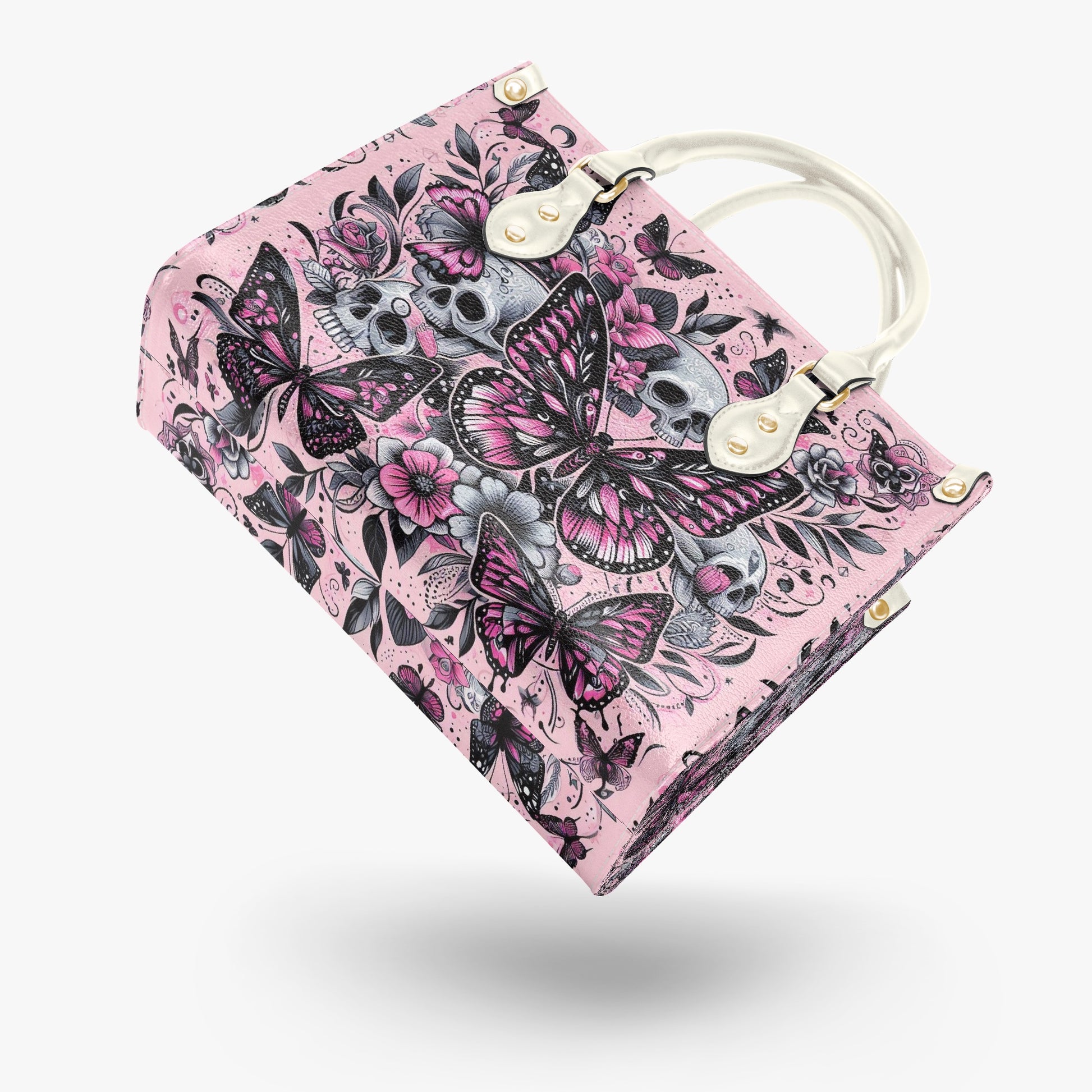 Pink notebook with butterfly and skull design on a white background