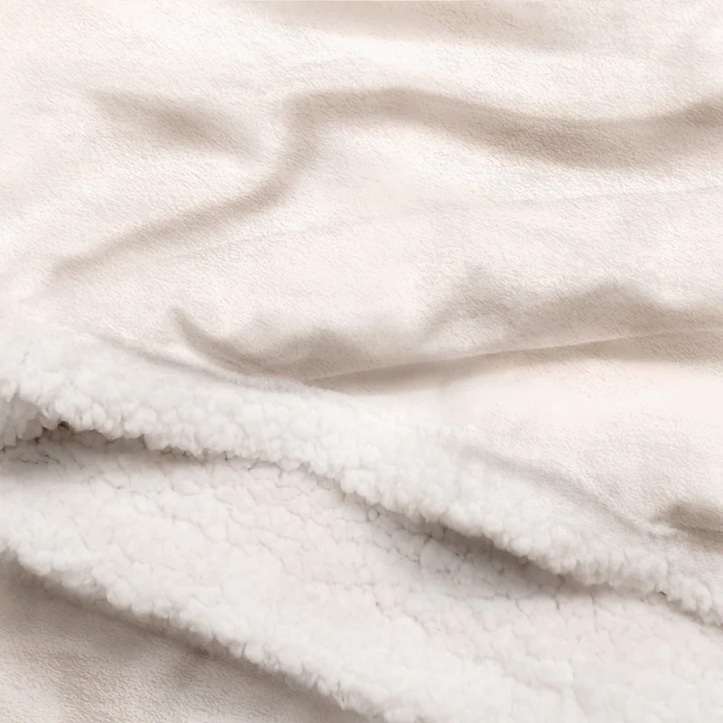 Soft white fleece blanket with plush sherpa lining, cozy and warm texture.