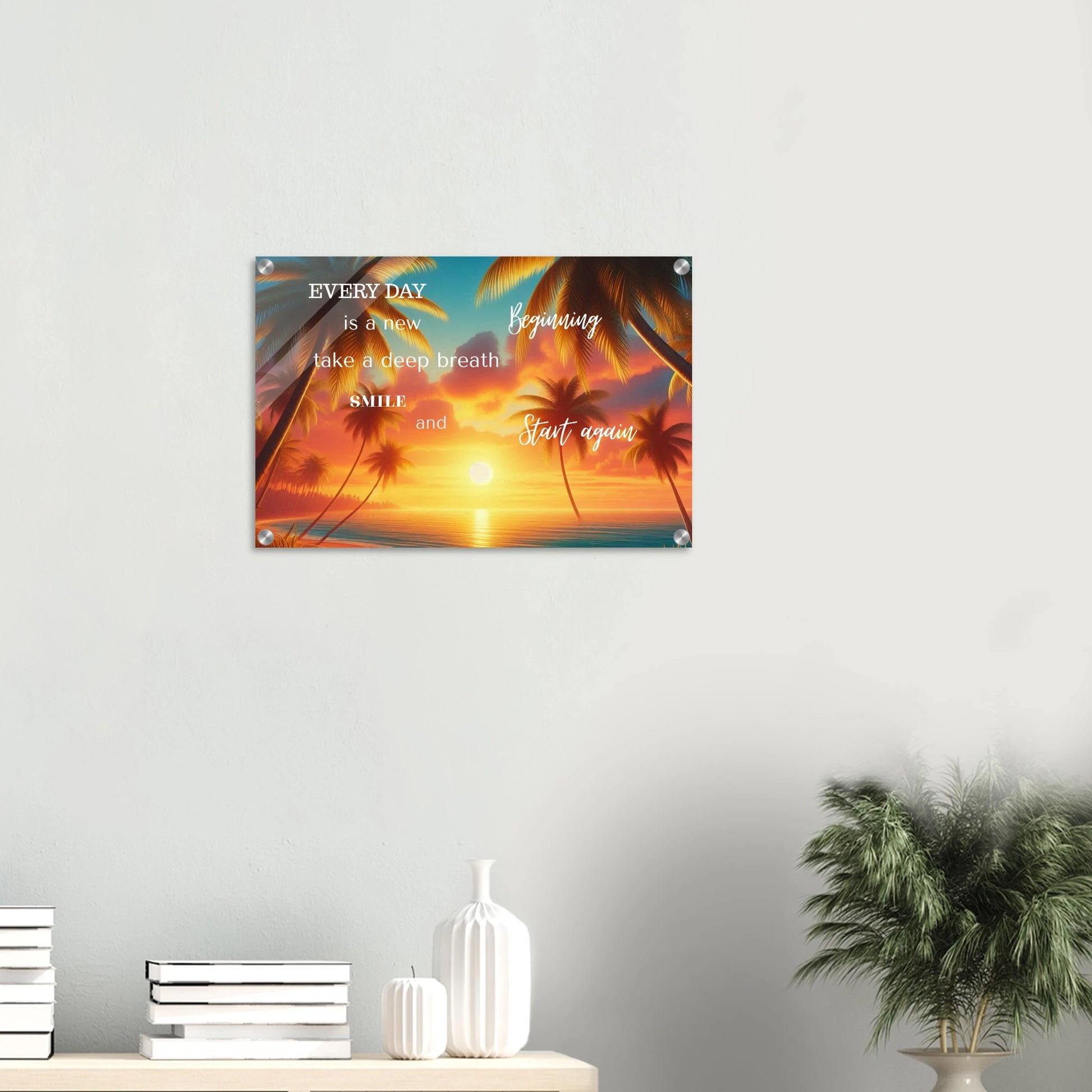 Decorative wall poster with motivational quote and palm trees on a sunset background, mounted on a wall.