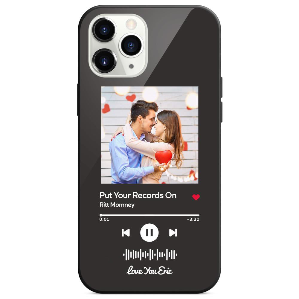 Close-up of a black phone case showing a couple embracing and holding a heart, styled as a music player interface with song title and artist name.