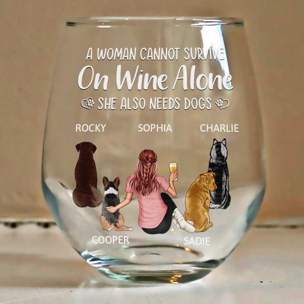 A clear glass wine glass with a woman, dogs, and text.