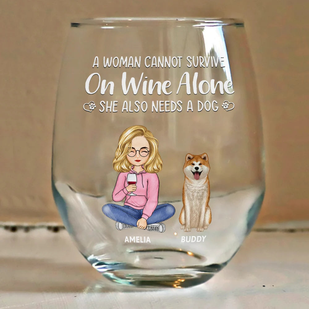 Stemless wine glass with a woman, a dog, and the saying "A woman cannot survive on wine alone, she also needs a dog".