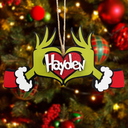 Personalized Grinch-themed Christmas ornament with the name "Hayden" in a heart shape, a unique Christmas gift.