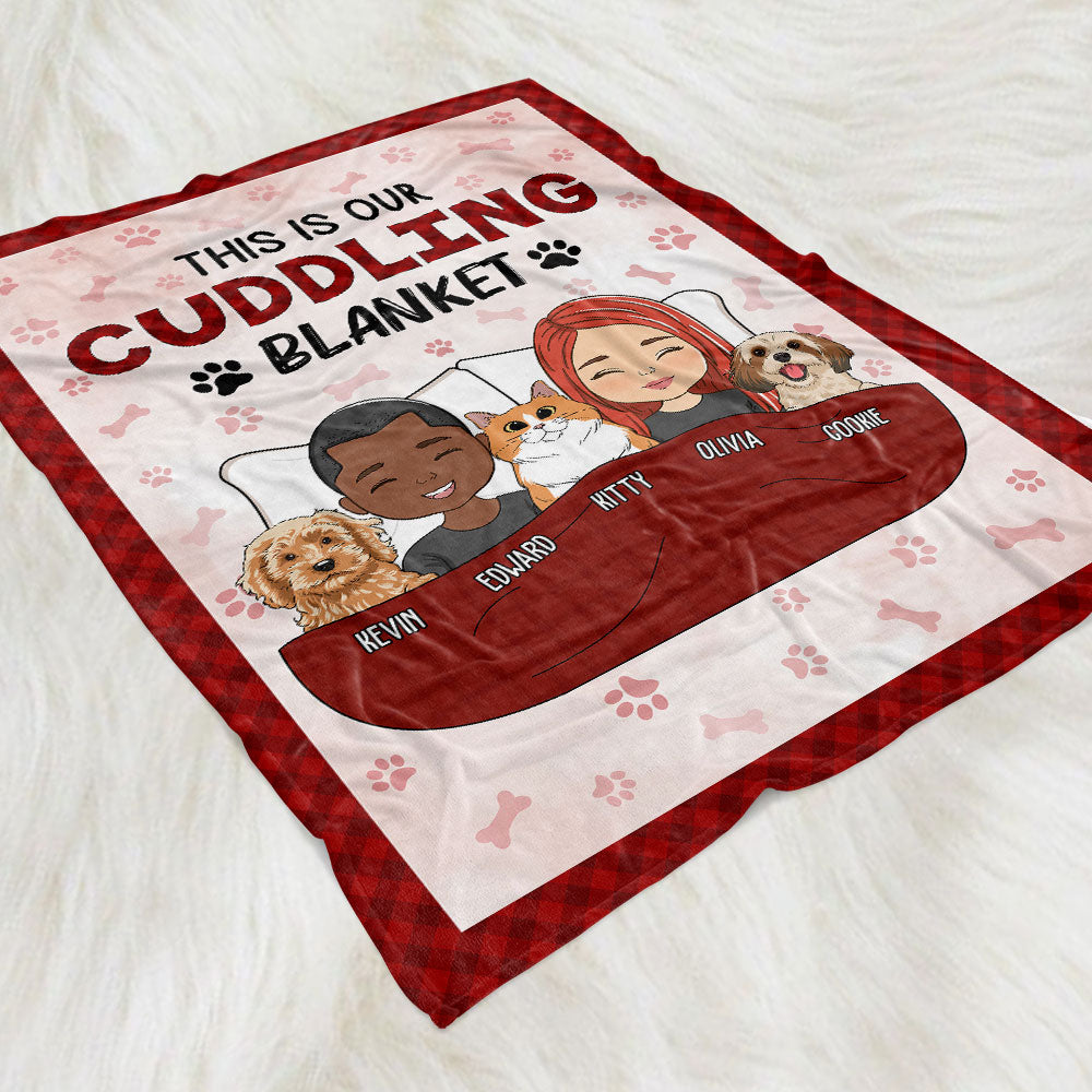 Personalized fleece blanket with red border, cartoon couple and pets under a red blanket, paw prints, and "This Is Our.