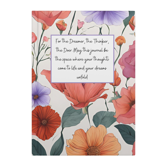 Notebook with large red, orange, pink, and purple flowers and a white label reading dreamer, thinker, doer quote.