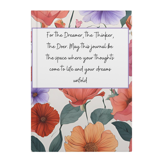Notebook with vibrant orange, red, and purple floral cover and handwritten inspirational quote on front.