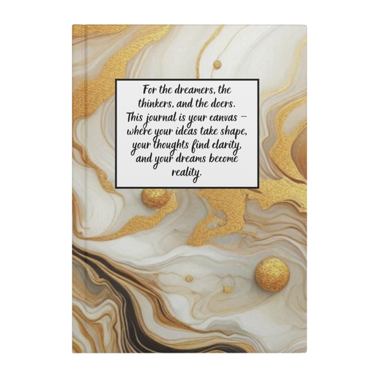 Notebook with marbled gold, beige, and white cover and inspirational quote in black script on white label.