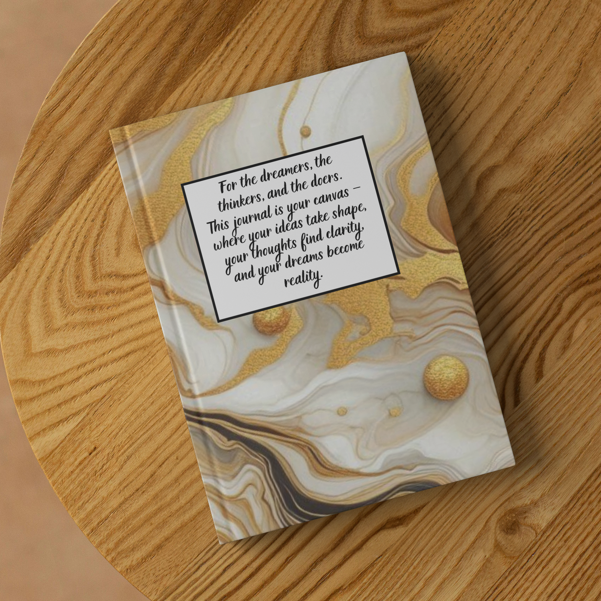 Notebook with beige and gold marbled cover and motivational quote on front about dreams, thoughts, and reality.