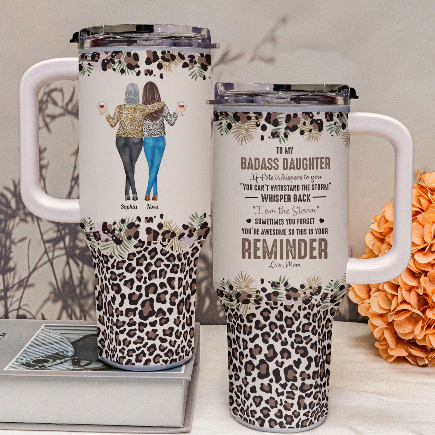 Two personalized leopard print tumblers with handles, one featuring a mother-daughter illustration.