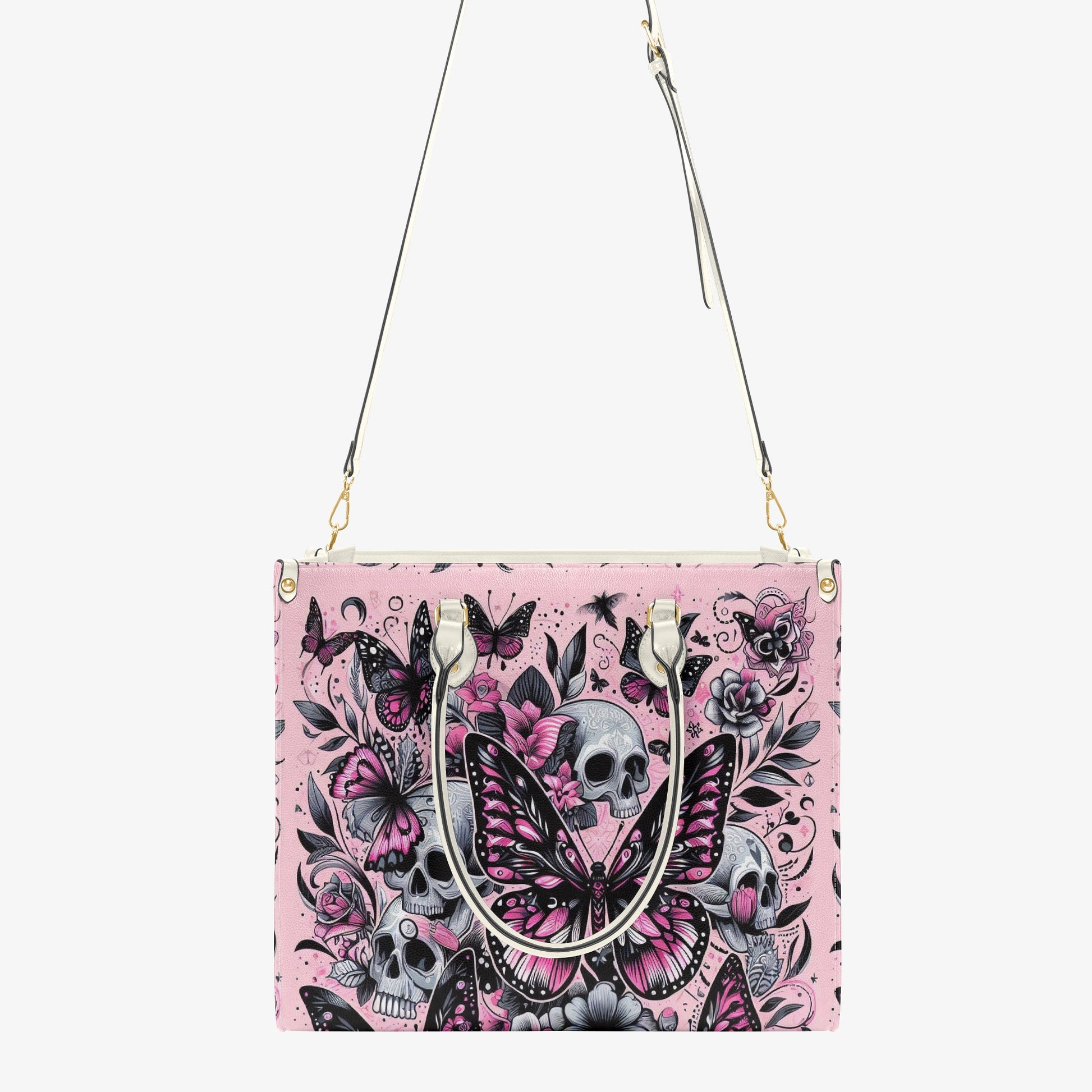 Handbag with skull and butterfly design on a pink background