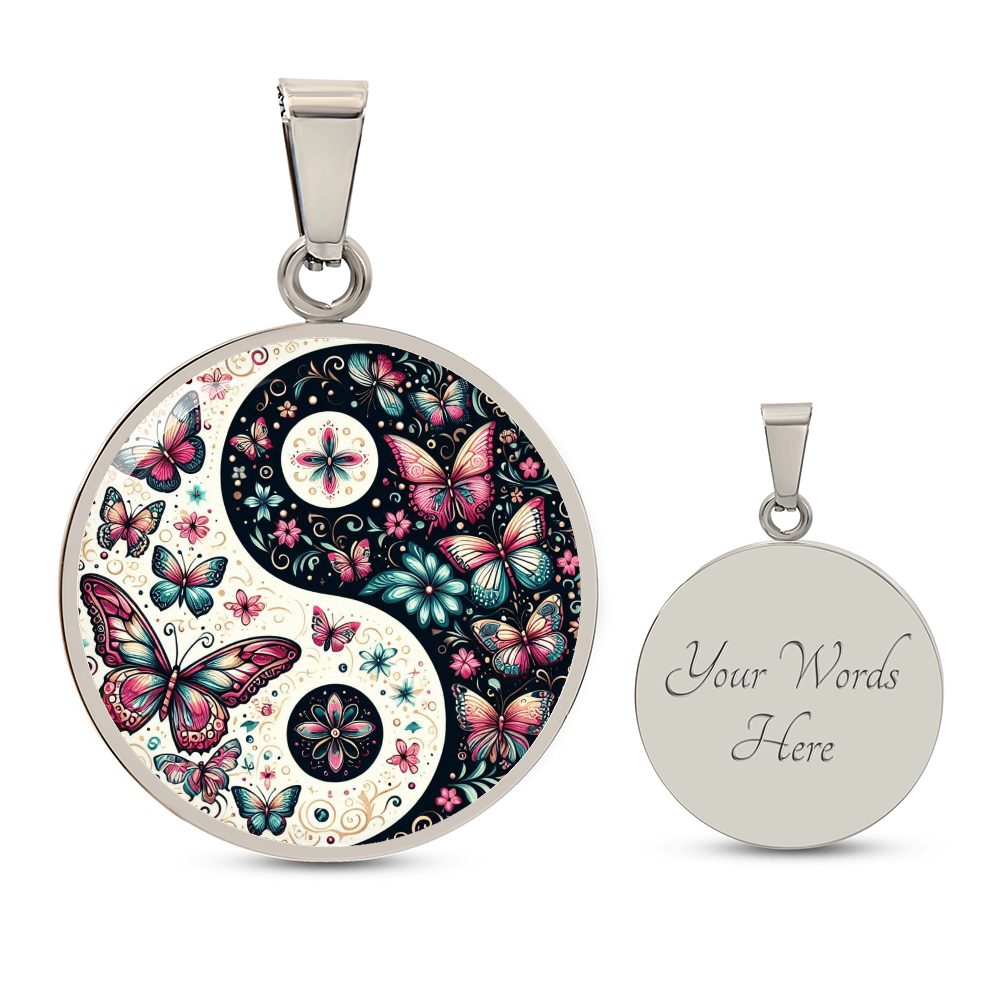 Two circular pendant necklaces. One with a yin-yang symbol filled with butterflies and flowers. The second blank pendant has the words "Your Words Here." Both pendants are silver with silver bails.