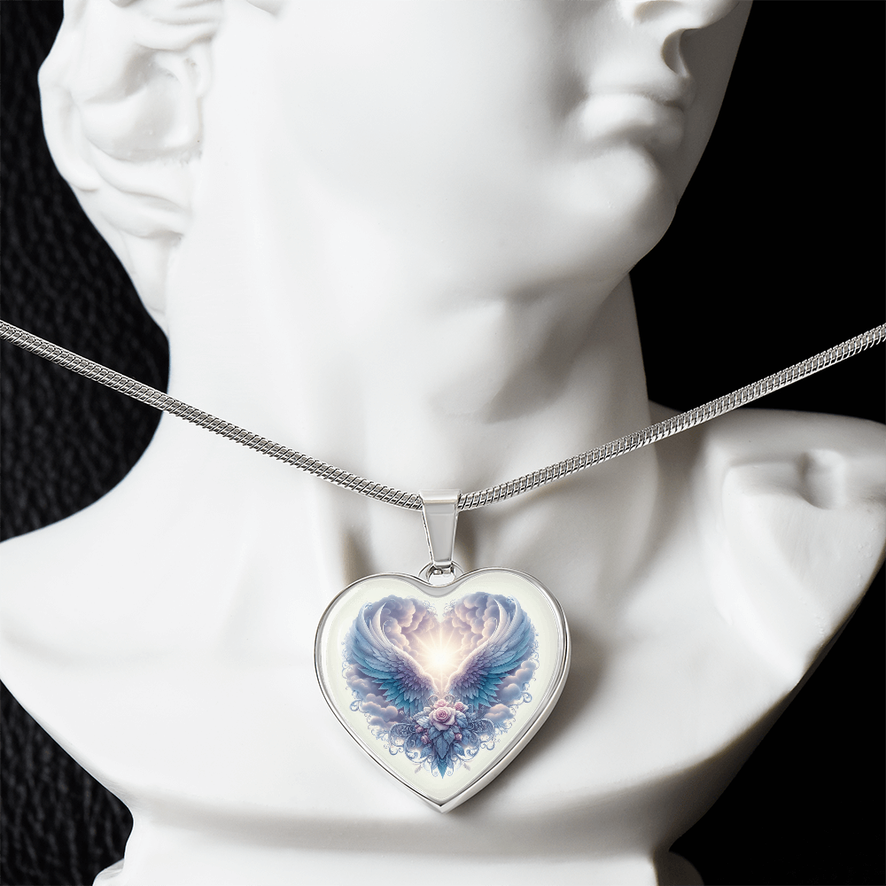 Silver heart-shaped necklace pendant with angel wings and glowing blue graphic design on a silver chain.