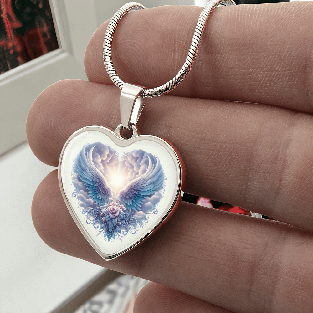 Silver heart-shaped necklace pendant with angel wings and glowing light design on a silver chain.