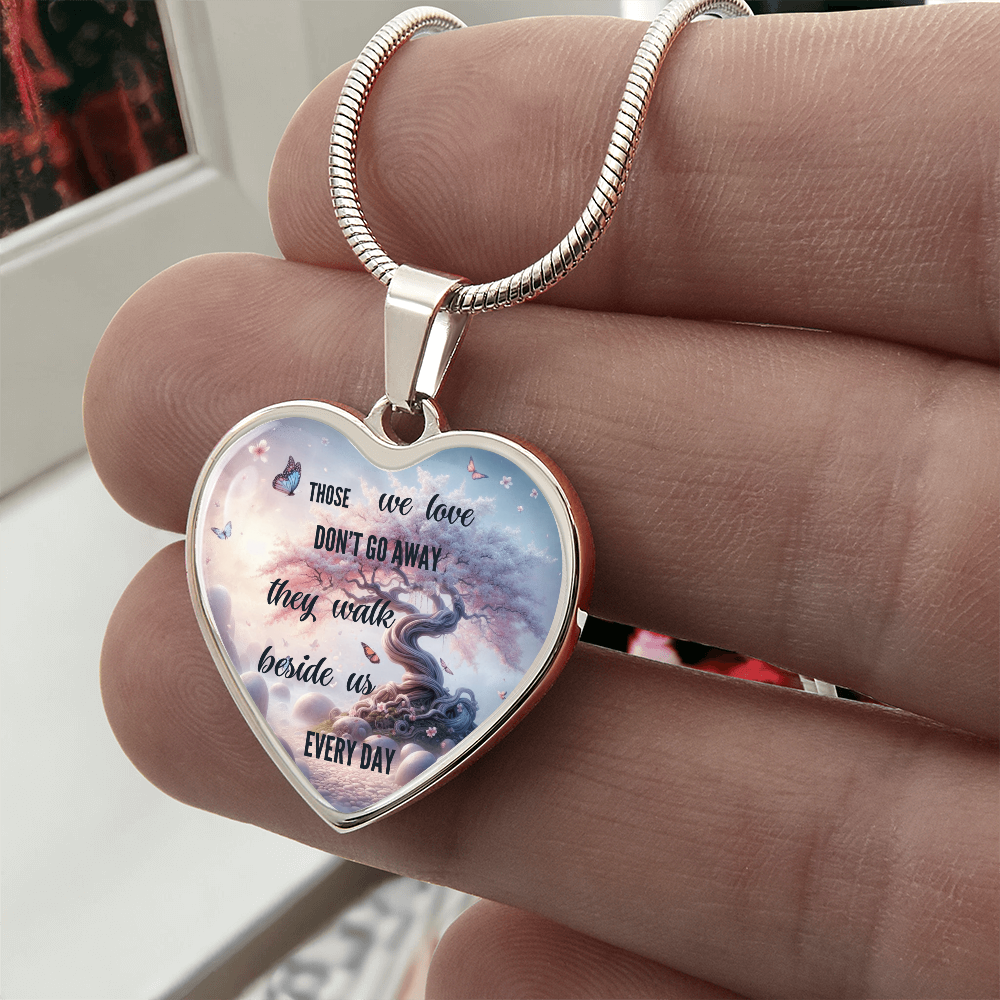 Silver heart-shaped pendant necklace with engraved sentimental message and butterfly design.