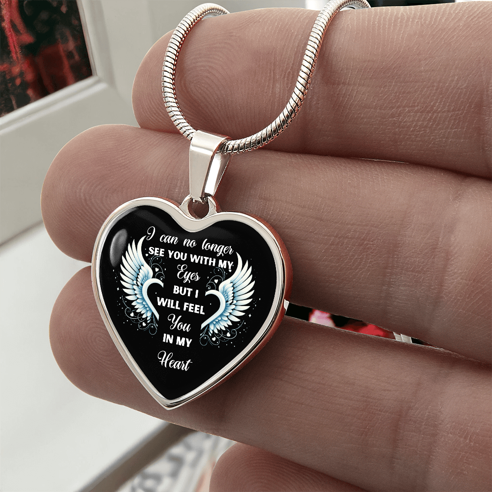 Silver heart necklace pendant with memorial inscription.