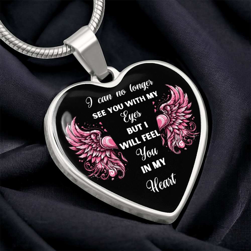 Silver heart pendant necklace with engraved pink wings and script remembrance quote on black background.