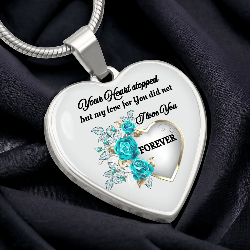 Silver heart-shaped pendant necklace with blue floral design and engraved love message.