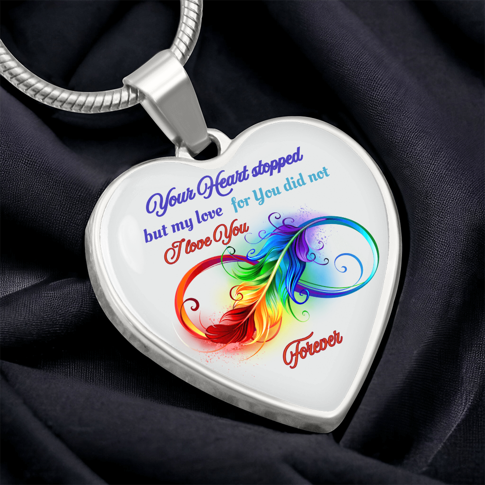 Silver heart pendant necklace with colorful feather design and loving memorial message.