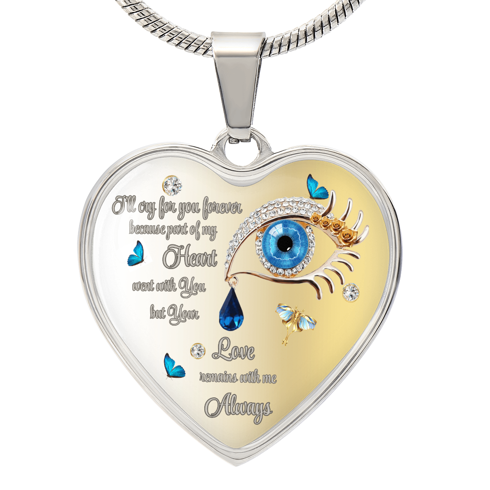 Heart-shaped pendant necklace with silver frame, blue eye, teardrop jewel, butterfly accents, and sentimental inscription.
