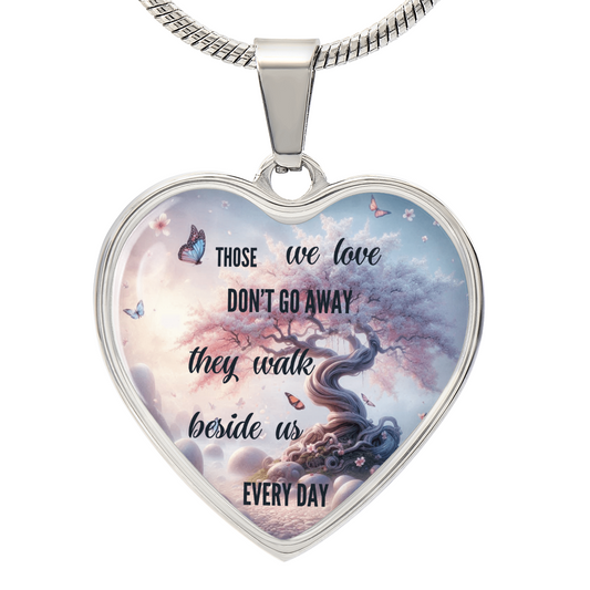 Silver heart-shaped pendant necklace with tree and butterfly design, inscribed with "Those we love don't go away they walk.