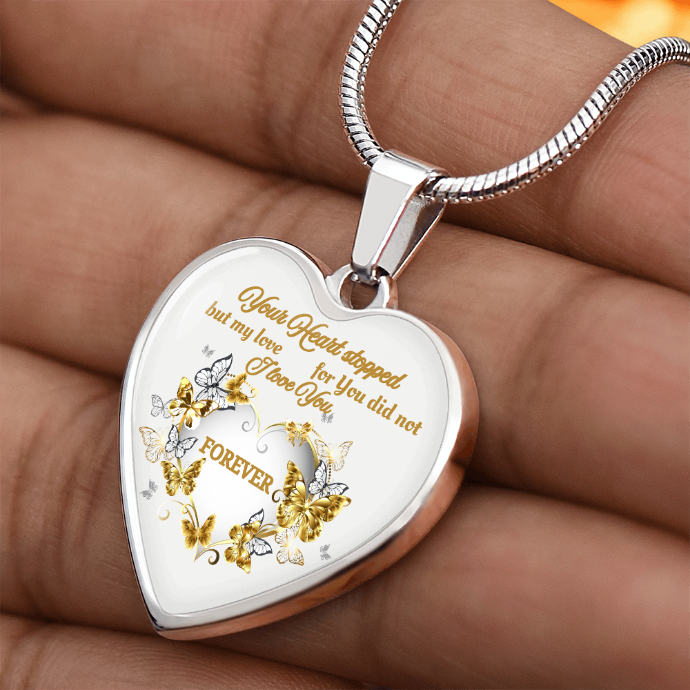 Silver heart pendant necklace with engraved butterflies and "Your Heart Stopped but My Love for You Did Not" text.