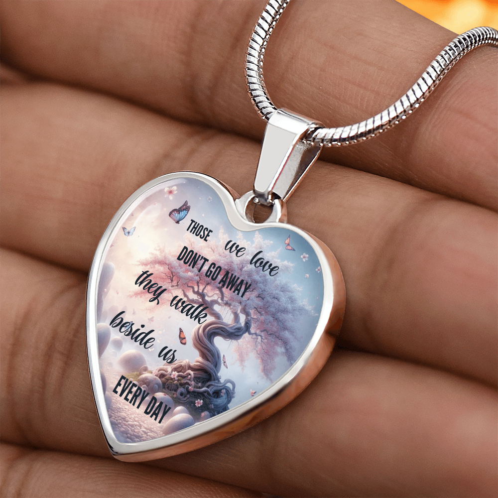 Silver heart-shaped pendant necklace with engraved tree and sentimental sympathy message.