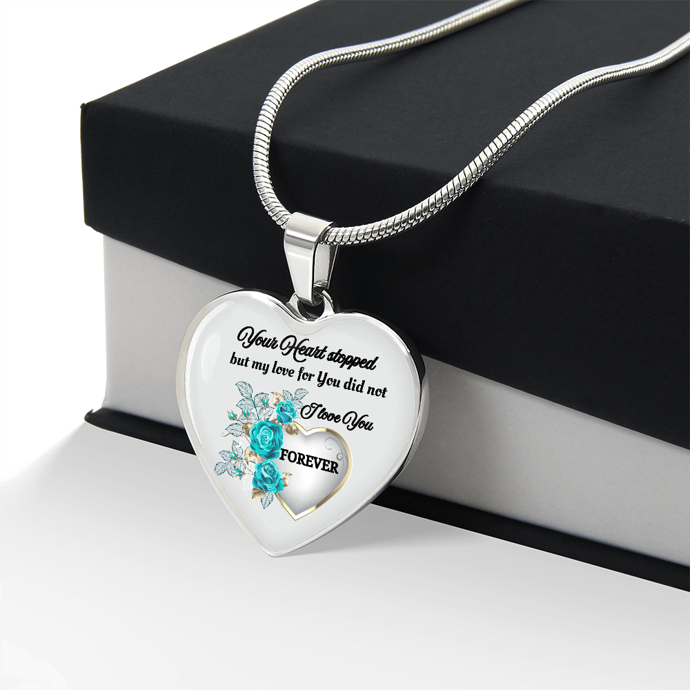 Silver heart pendant necklace with blue flowers and engraved memorial message on snake chain.