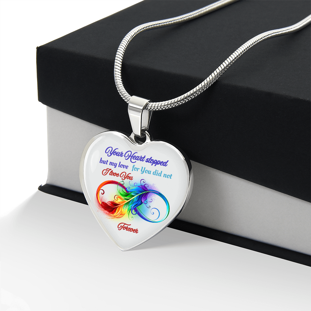 Silver heart-shaped pendant necklace with colorful flame design and sentimental text on front.