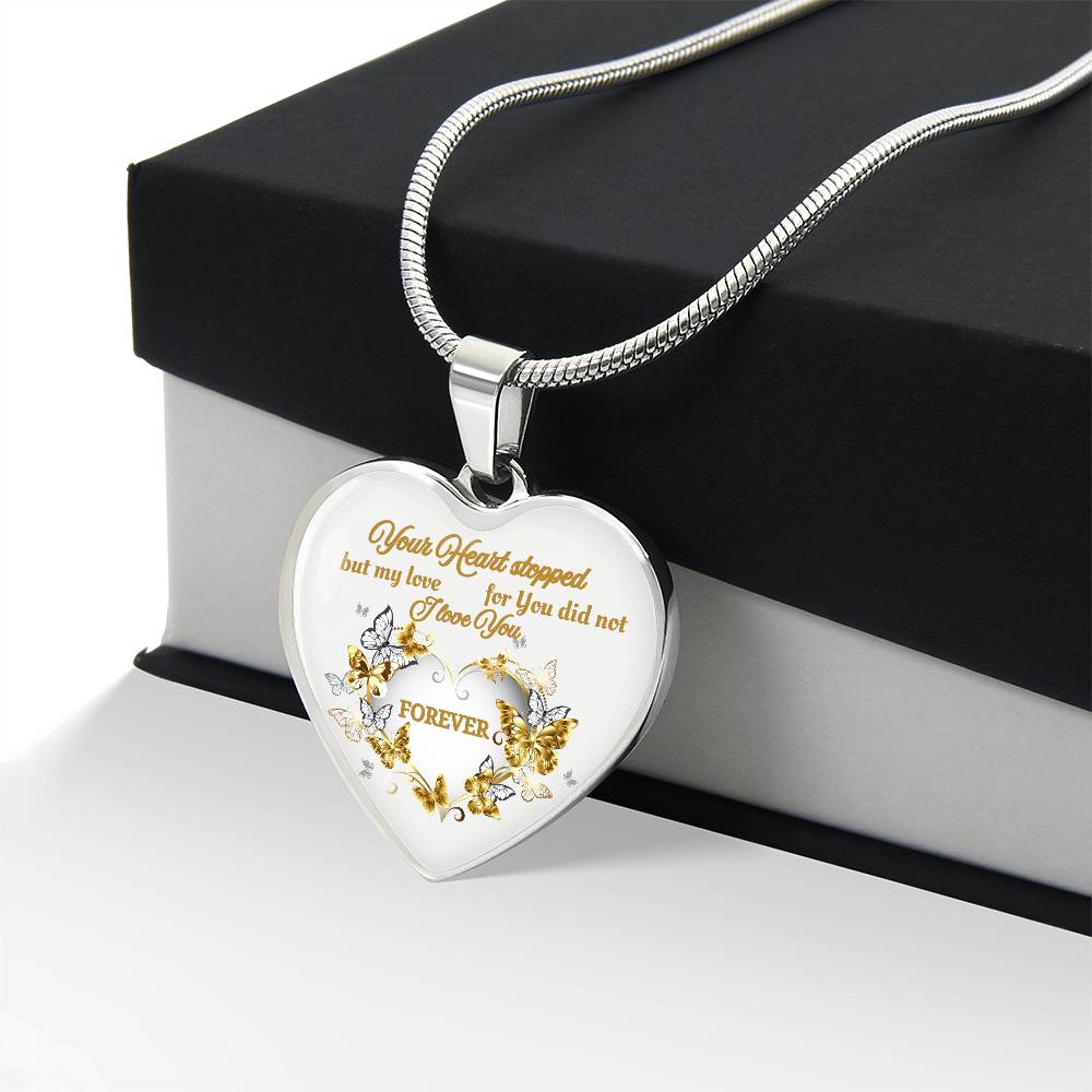 Silver heart pendant necklace with gold floral engraving and heartfelt script on a snake chain.