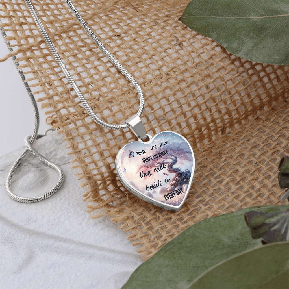Silver heart-shaped necklace pendant with engraved sentimental phrase on delicate chain.