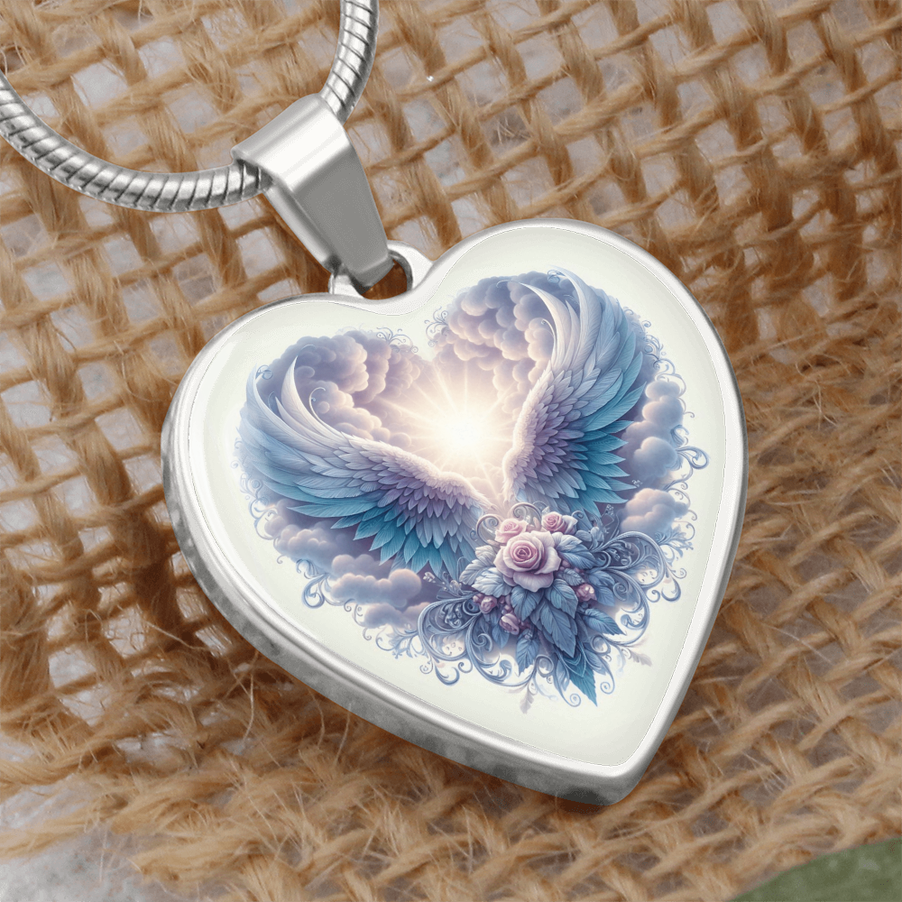 Silver heart-shaped pendant necklace with angel wings and floral graphic design.