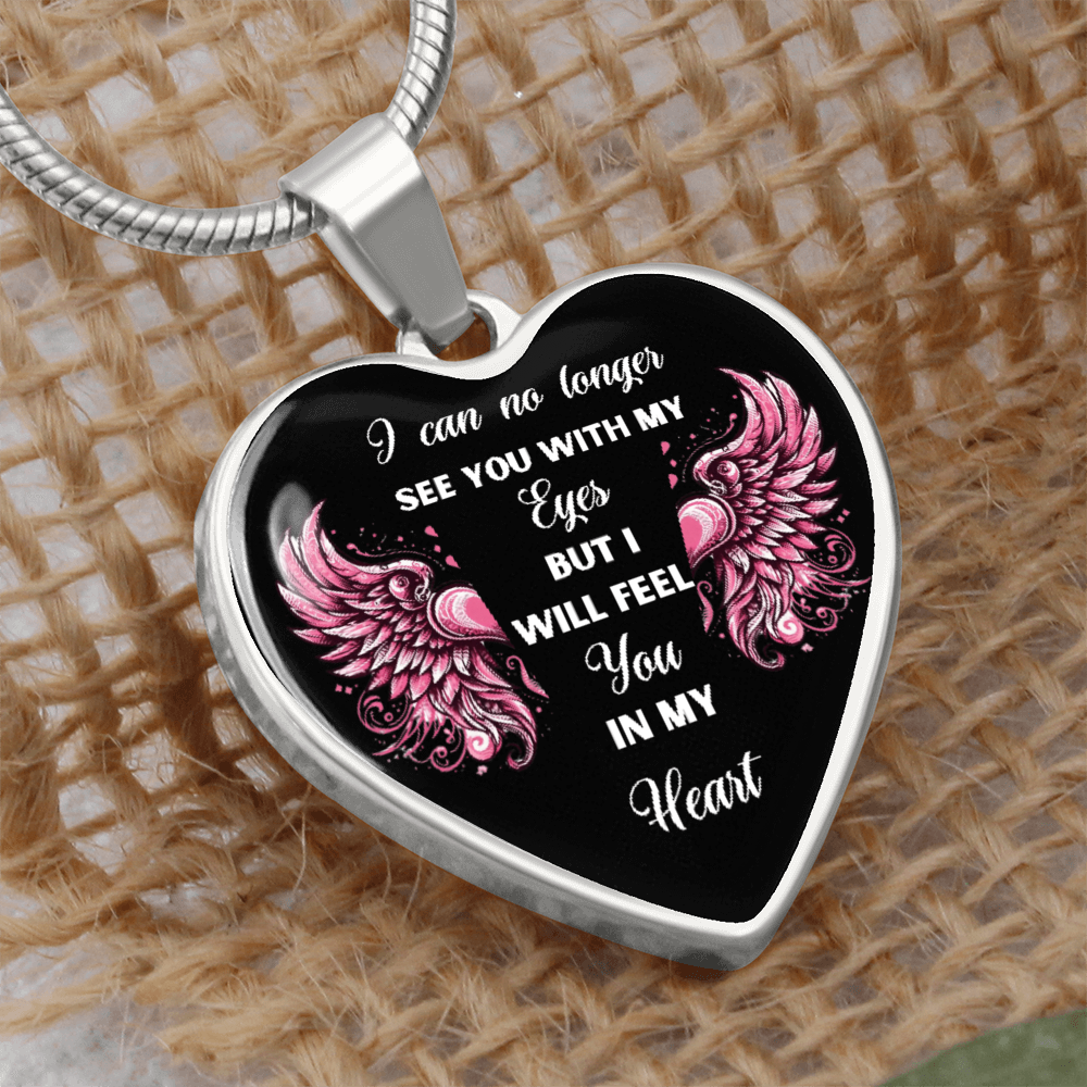 Silver heart-shaped pendant necklace with pink angel wings and sentimental white text on black background.