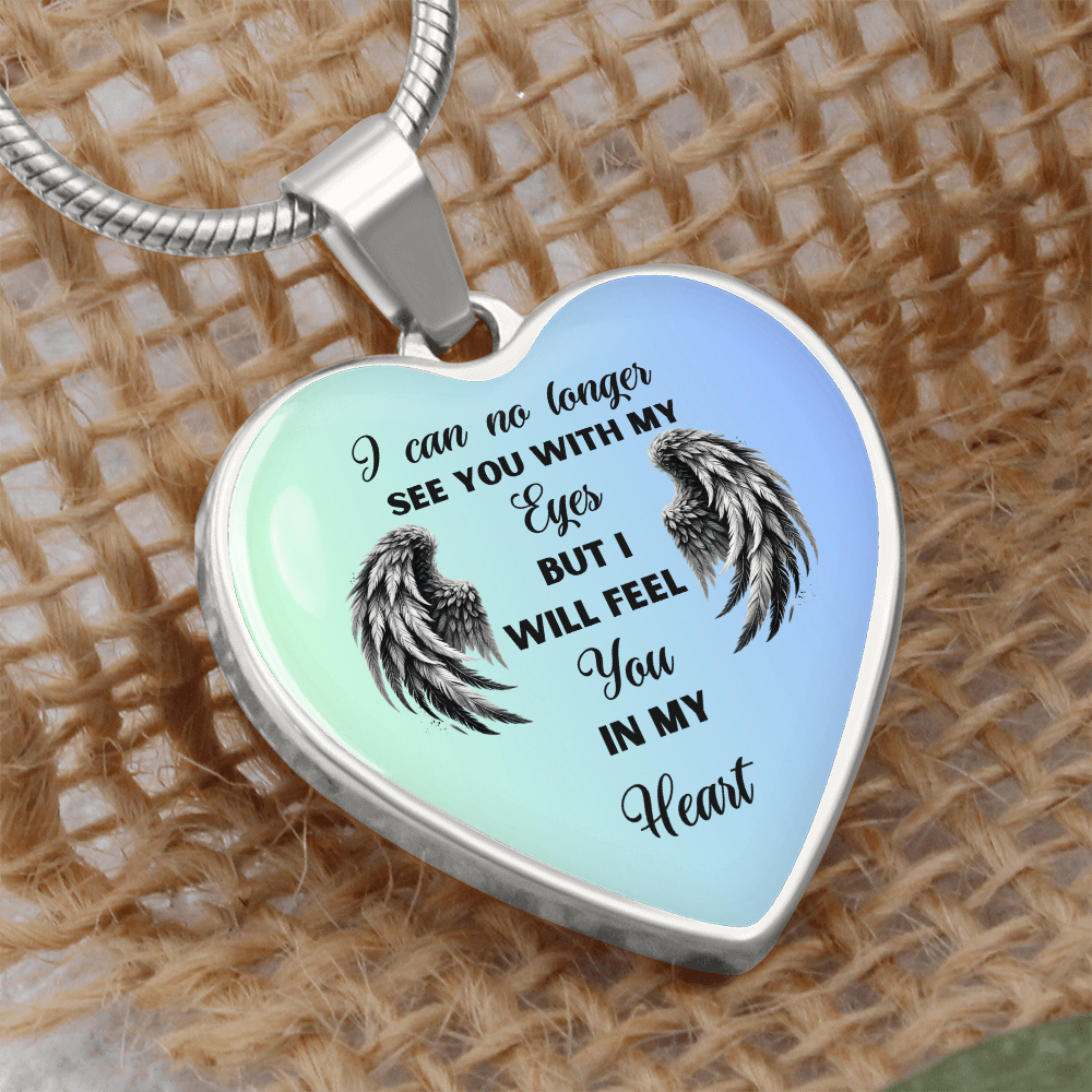 Heart-shaped necklace pendant with angel wings and sentimental quote.