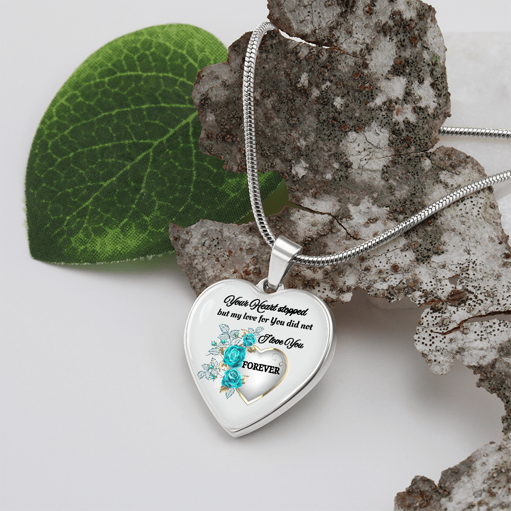 Silver heart pendant necklace with blue flowers and engraved sentimental message.