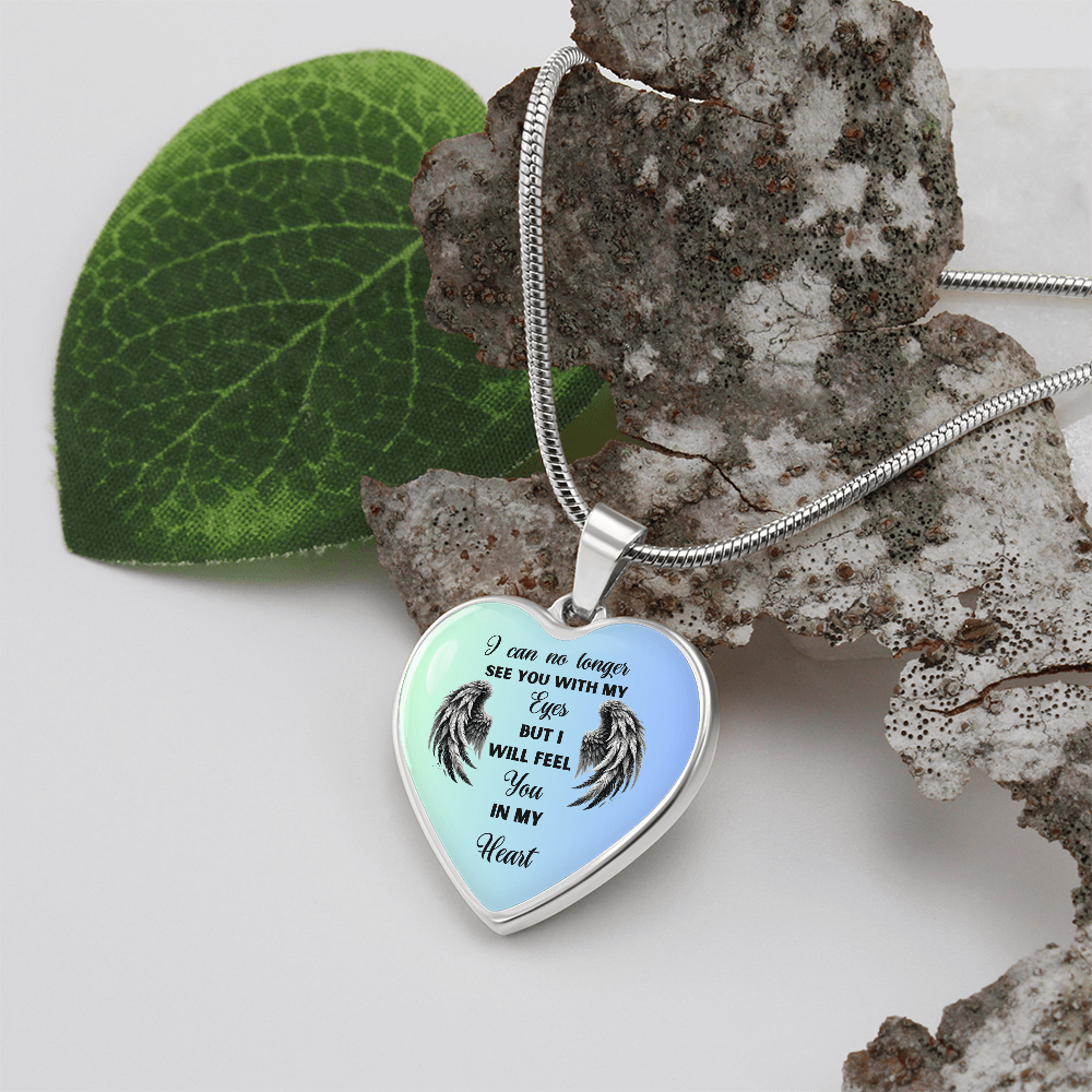 Heart-shaped pendant necklace with angel wings design and memorial text.