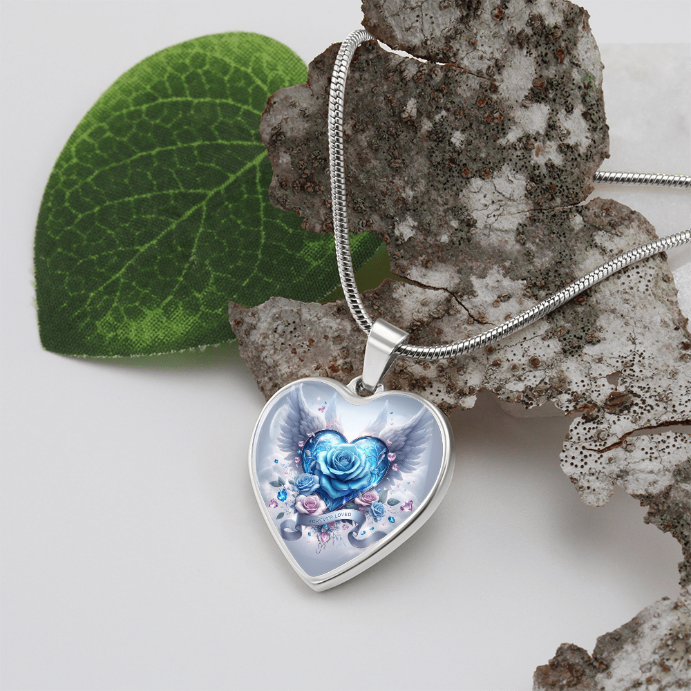 Silver heart pendant necklace with blue rose and angel wings design on snake chain.