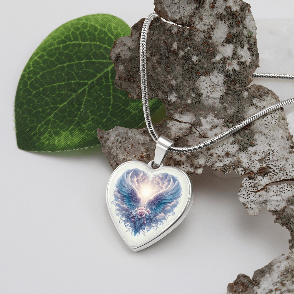 Silver heart-shaped pendant necklace with glowing angel wings graphic on white background.