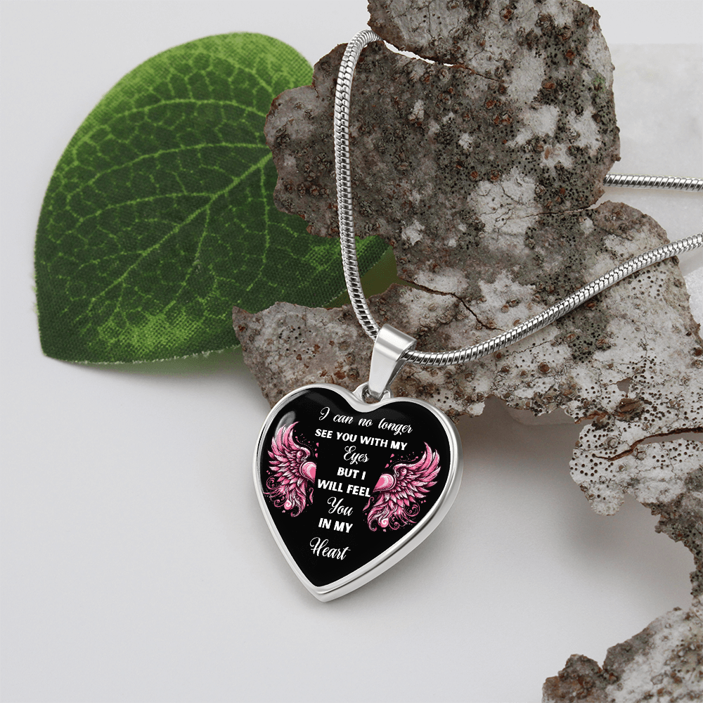 Silver heart-shaped pendant necklace with black center and pink floral accents, engraved sympathy message.