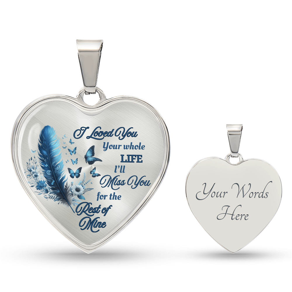 Silver heart-shaped pendant necklace with blue feather and engraving, butterfly accents.