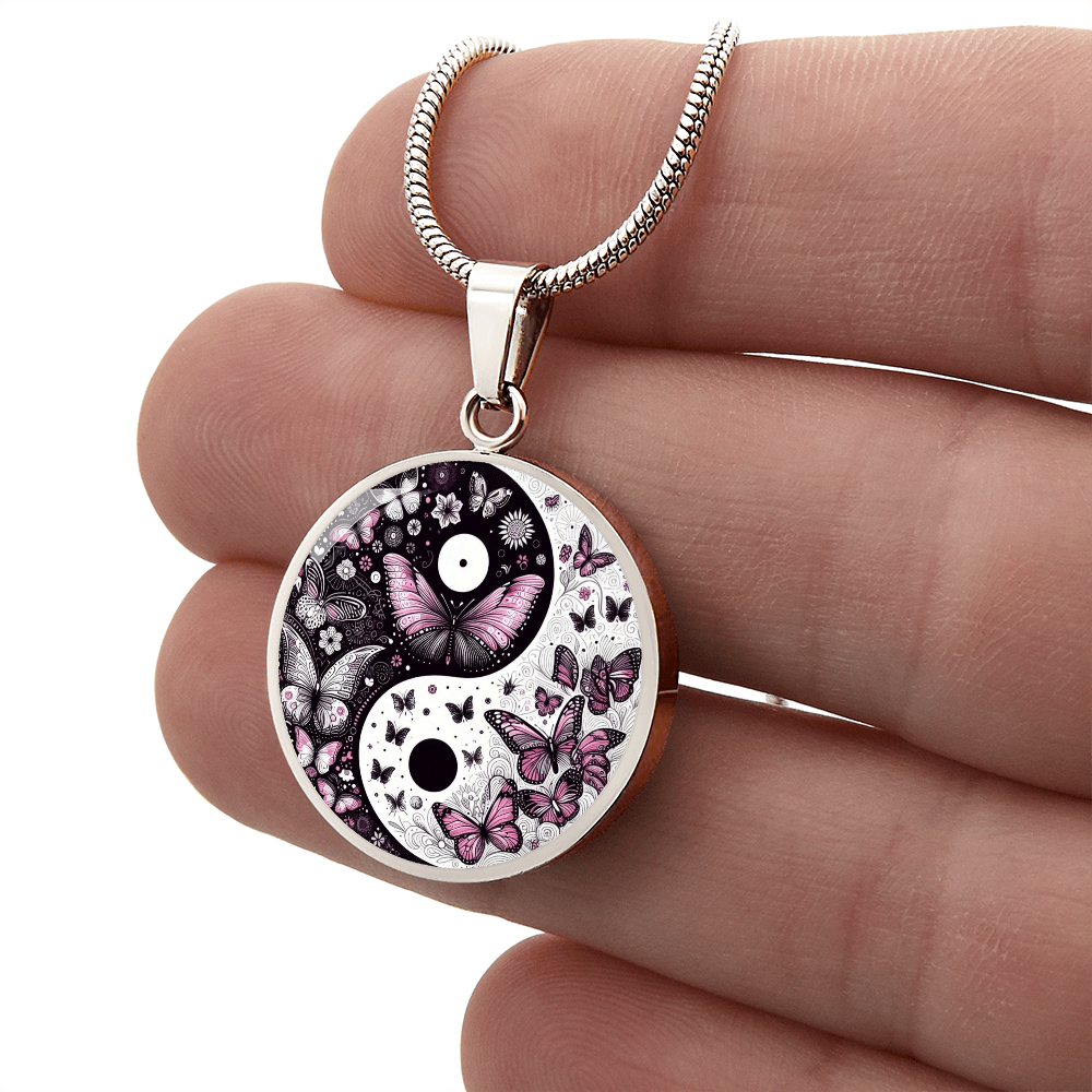 Silver circular necklace pendant featuring a yin yang design with violet butterflies on a silver chain.