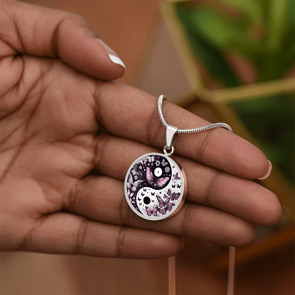 Silver circular necklace pendant with black and white yin yang design and violet butterflies on silver chain.