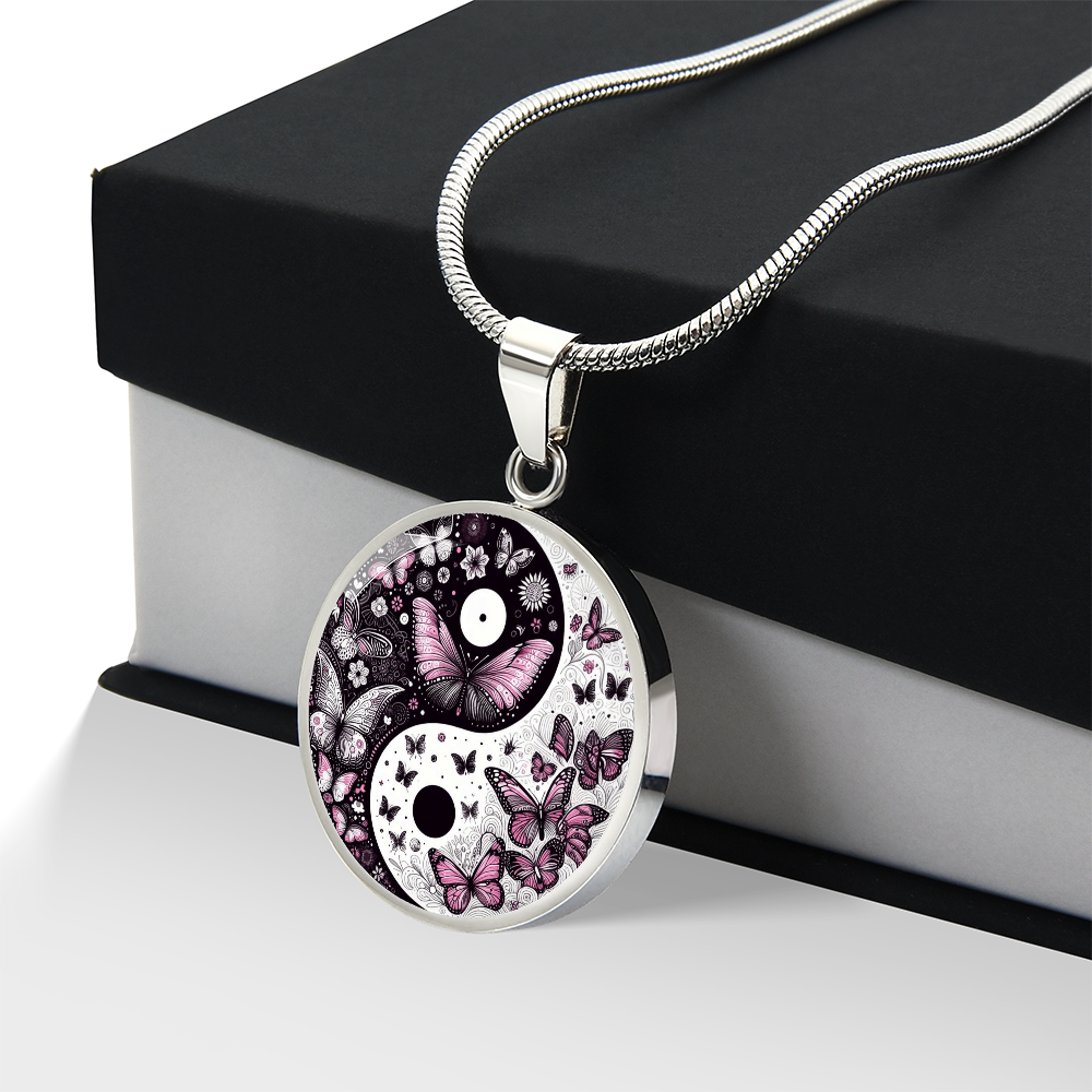 Silver necklace with round yin yang pendant featuring violet butterflies and floral accents.