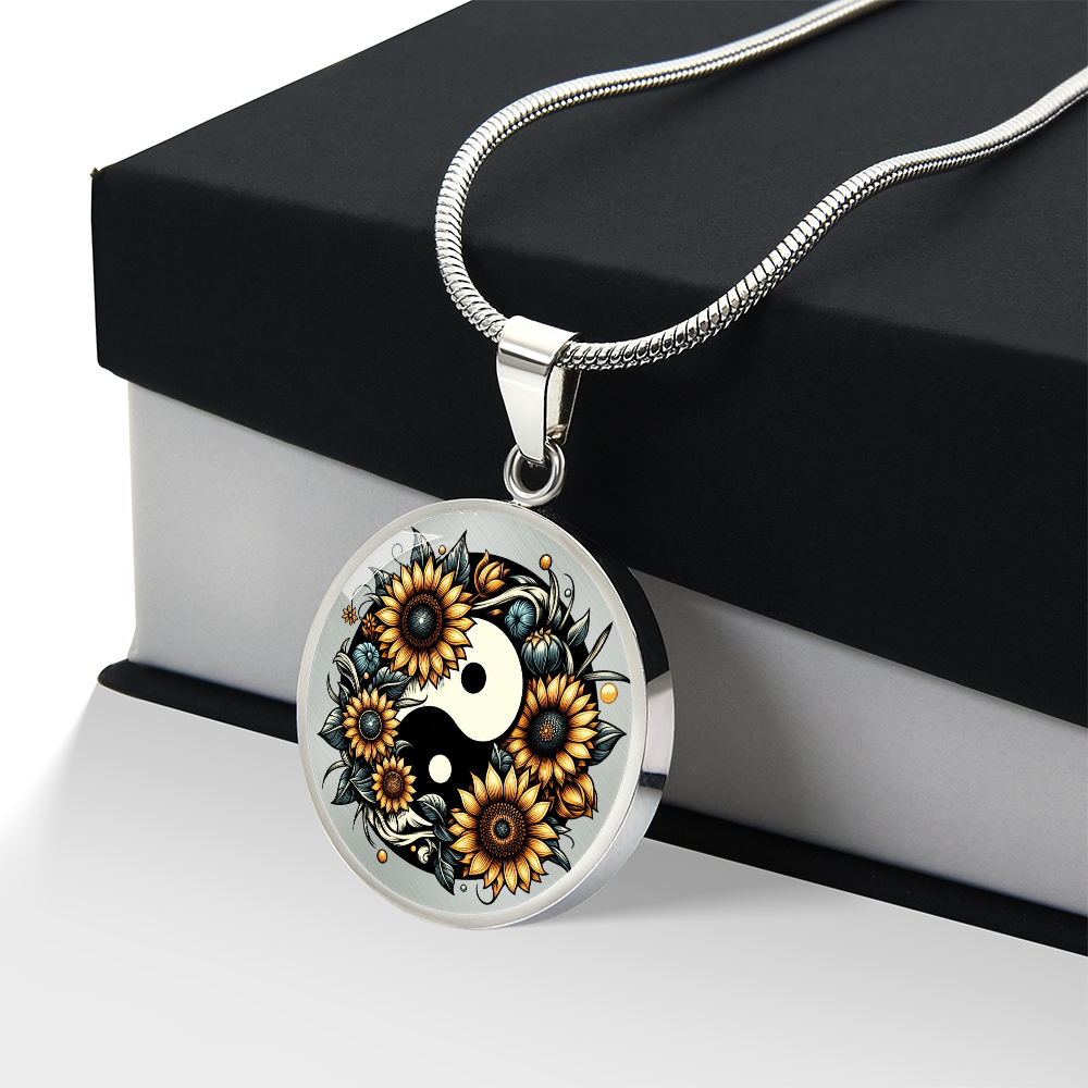 Silver necklace with round yin yang pendant featuring detailed sunflowers and black leaf accents.