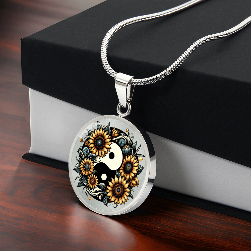 Silver circle necklace pendant with a yin yang symbol surrounded by vibrant sunflowers.