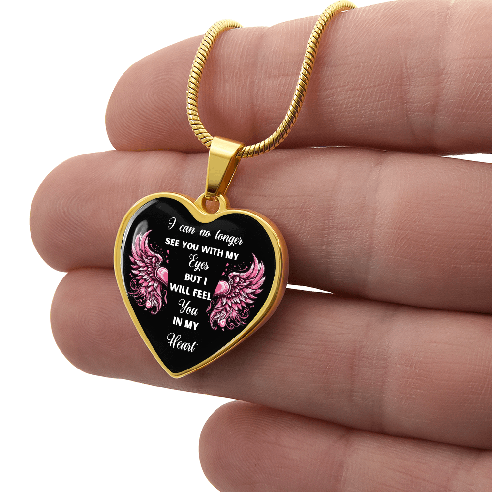 Gold heart-shaped pendant necklace with pink floral accents and engraved sympathy message on black background.