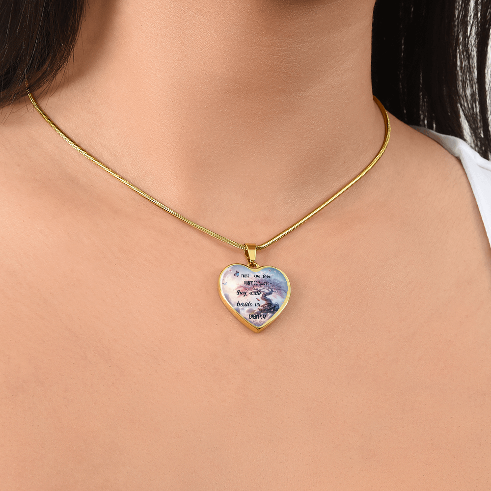 Gold heart-shaped pendant necklace with sentimental text and delicate cloud design on white background.